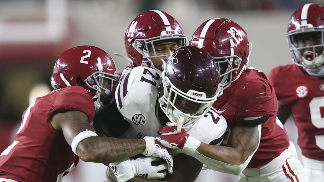 Oct 31, 2020; Tuscaloosa, Alabama, USA;  Alabama defensive back Patrick Surtain II (2), Alabama defensive back Brian Branch (14) and Alabama defensive back Malachi Moore (13) combine to tackle Mississippi State running back Jo'quavious Marks (21) at Bryant-Denny Stadium during the second half of Alabama's 41-0 win over Mississippi State. Mandatory Credit: Gary Cosby Jr/The Tuscaloosa News via Imagn Images
