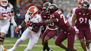 Nov 9, 2024; Blacksburg, Virginia, USA;  Clemson Tigers running back Phil Mafah (7) runs the ball as Virginia Tech Hokies linebacker Jaden Keller (24) reaches for the tackle during the second quarter at Lane Stadium. Mandatory Credit: Brian Bishop-Imagn Images