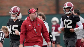 Quarterbacks coach Nick Sheridan walks between quarterbacks Ty Simpson (15) and Keelon Russell (12