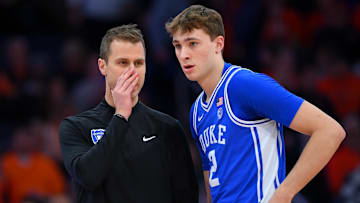 Feb 5, 2025; Syracuse, New York, USA; Duke Blue Devils head coach Jon Scheyer talks with guard Cooper Flagg (2) against the Syracuse Orange during the first half at the JMA Wireless Dome. Mandatory Credit: Rich Barnes-Imagn Images