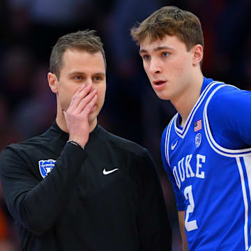Feb 5, 2025; Syracuse, New York, USA; Duke Blue Devils head coach Jon Scheyer talks with guard Cooper Flagg (2) against the Syracuse Orange during the first half at the JMA Wireless Dome. Mandatory Credit: Rich Barnes-Imagn Images