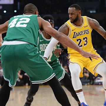 March 9, 2019; Los Angeles, CA, USA; Los Angeles Lakers forward LeBron James (23) moves the ball against Boston Celtics center Al Horford (42) during the first half at Staples Center. Mandatory Credit: Gary A. Vasquez-Imagn Images