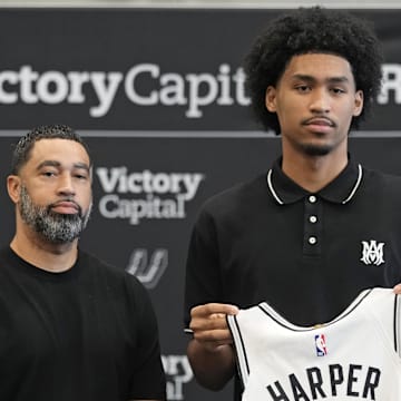 Jun 28, 2025; San Antonio, TX, USA; San Antonio first round draft pick Dylan Harper (2) holds up his jersey along with general manager Brian Wright at Victory Capital Performance Center. Mandatory Credit: Scott Wachter-Imagn Images