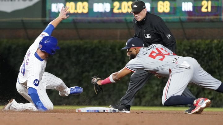 Chicago Cubs first baseman Michael Busch (29) is safe at second base as Minnesota Twins shortstop Willi Castro (50) makes a late tag during the fifth inning at Wrigley Field in Chicago on Aug. 6, 2024. 