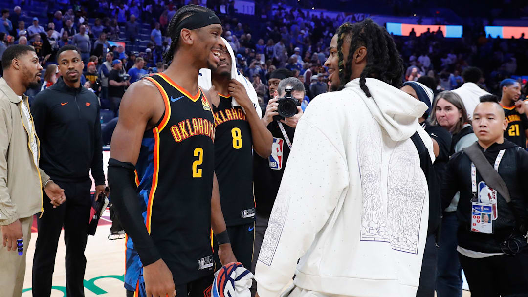 Dec 29, 2024; Oklahoma City, Oklahoma, USA;  Oklahoma City Thunder guard Shai Gilgeous-Alexander (2) and Memphis Grizzlies guard Ja Morant (12) meet after their game at Paycom Center. Mandatory Credit: Alonzo Adams-Imagn Images