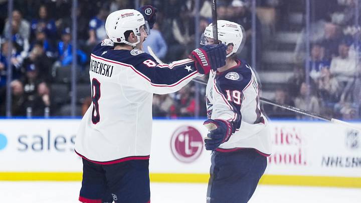Nov 20, 2025; Toronto, Ontario, CAN; Columbus Blue Jackets center Adam Fantilli (19) scores the winning goal and celebrates with defenseman Zach Werenski (8) against the Toronto Maple Leafs during the overtime period at Scotiabank Arena. Mandatory Credit: Nick Turchiaro-Imagn Images
