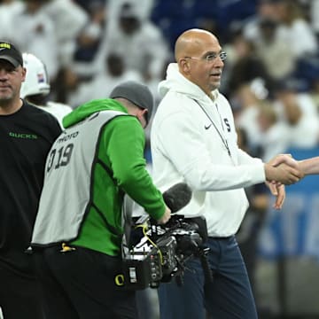 Dec 7, 2024; Indianapolis, IN, USA; Penn State Nittany Lions head coach James Franklin shakes hands with Oregon Ducks head coach Dan Lanning in the 2024 Big Ten Championship game at Lucas Oil Stadium.