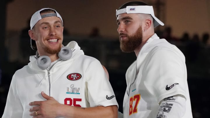 Jan 27, 2020; Miami, FL, USA;  San Francisco 49ers tight end George Kittle (85) greets Kansas City Chiefs tight end Travis Kelce (87) during Super Bowl LIV Opening Night at Marlins Park.  Mandatory Credit: Kirby Lee-USA TODAY Sports