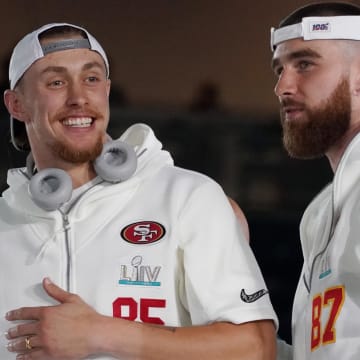 Jan 27, 2020; Miami, FL, USA;  San Francisco 49ers tight end George Kittle (85) greets Kansas City Chiefs tight end Travis Kelce (87) during Super Bowl LIV Opening Night at Marlins Park.  Mandatory Credit: Kirby Lee-USA TODAY Sports