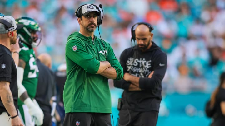 Dec 17, 2023; Miami Gardens, Florida, USA; New York Jets quarterback Aaron Rodgers (8) looks on from the sideline against the Miami Dolphins during the fourth quarter at Hard Rock Stadium.