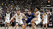 Jul 12, 2025; Las Vegas, NV, USA; Dallas Mavericks forward Cooper Flagg (32) dribbles against San Antonio Spurs guard Kyle Mangas (16) and guard Dylan Harper (2) in the second quarter of their game at Thomas & Mack Center. Mandatory Credit: Candice Ward-Imagn Images