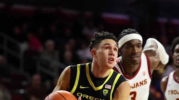 Oregon Ducks guard Jackson Shelstad (3) drives to the basket past USC Trojans forward Vincent Iwuchukwu (3)