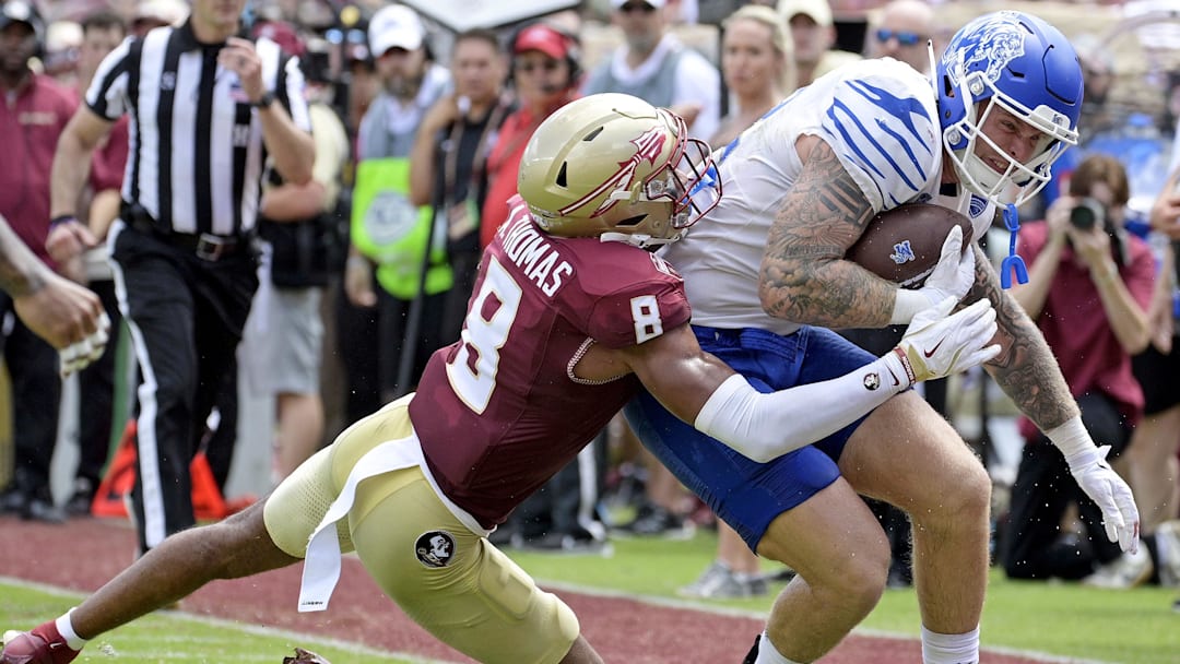 Sep 14, 2024; Tallahassee, Florida, USA; Memphis Tigers tight end Anthony Landphere (82) is tackled by Florida State Seminoles defensive back Azareye'h Thomas (8) during the first half at Doak S. Campbell Stadium.