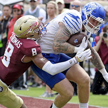 Sep 14, 2024; Tallahassee, Florida, USA; Memphis Tigers tight end Anthony Landphere (82) is tackled by Florida State Seminoles defensive back Azareye'h Thomas (8) during the first half at Doak S. Campbell Stadium.