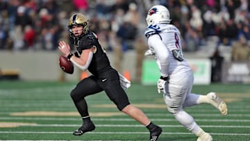 Nov 30, 2024; West Point, New York, USA; Army Black Knights quarterback Bryson Daily (13) scrambles away from UTSA Roadrunners linebacker Jimmori Robinson (8) during the first half at Michie Stadium. Mandatory Credit: Danny Wild-Imagn Images