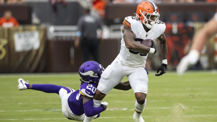 Aug 17, 2024; Cleveland, Ohio, USA; Cleveland Browns tight end Zaire Mitchell-Paden (83) runs the ball and slips a tackle by Minnesota Vikings safety Jay Ward (20) during the third quarter at Cleveland Browns Stadium. Mandatory Credit: Scott Galvin-USA TODAY Sports