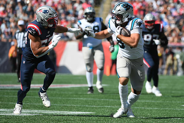 Mitchell Evans runs the ball while New England Patriots offensive tackle Marcus Bryant gives chase