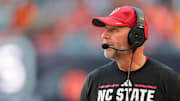 Nov 15, 2025; Miami Gardens, Florida, USA; NC State Wolfpack head coach Dave Doeren watches from the sideline against the Miami Hurricanes during the second quarter at Hard Rock Stadium. Mandatory Credit: Sam Navarro-Imagn Images