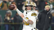 Dec 23, 2024; Green Bay, Wisconsin, USA;  New Orleans Saints quarterback Spencer Rattler (18) throws a pass during warmups prior to the game against the Green Bay Packers at Lambeau Field. Mandatory Credit: Jeff Hanisch-Imagn Images