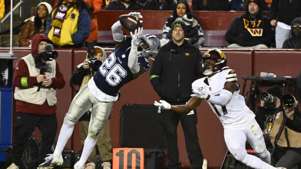 Dallas Cowboys cornerback DaRon Bland (26) intercepts a pass intended for Washington Commanders wide receiver Terry McLaurin 