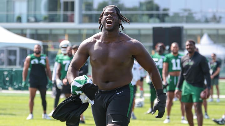 Jul 27, 2024; Florham Park, NJ, USA; New York Jets offensive tackle Olu Fashanu (74) runs up field greeting fans during training camp at Atlantic Health Jets Training Center. Mandatory Credit: Vincent Carchietta-USA TODAY Sports