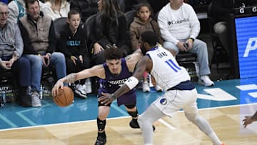 Jan 20, 2025; Charlotte, North Carolina, USA;  Charlotte Hornets guard LaMelo Ball (1) drives past Dallas Mavericks guard Kyrie Irving (11) during the first second at the Spectrum Center. Mandatory Credit: Sam Sharpe-Imagn Images