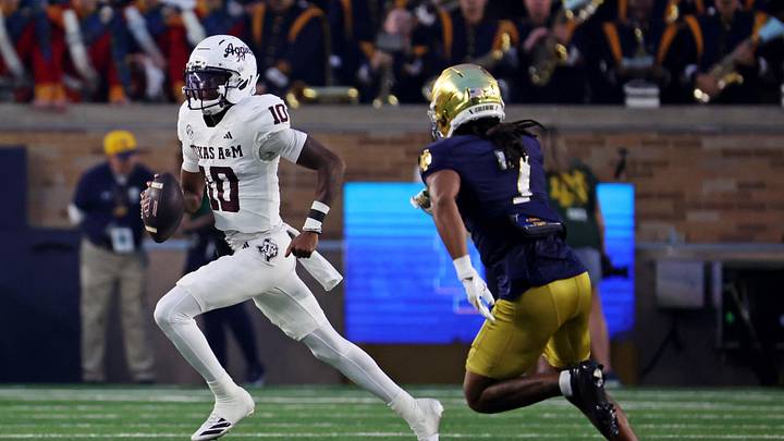 Sep 13, 2025; South Bend, Indiana, USA; Texas A&M Aggies quarterback Marcel Reed (10) runs the ball against Notre Dame Fighting Irish safety Jalen Stroman (7) during the first half at Notre Dame Stadium. Mandatory Credit: Trevor Ruszkowski-Imagn Images
