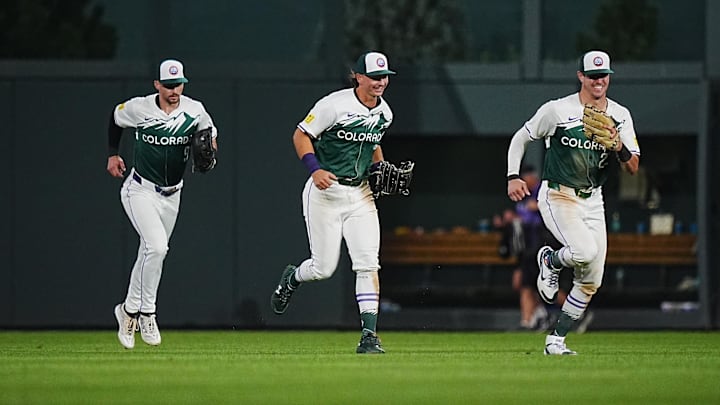 Aug 31, 2024; Denver, Colorado, USA; Colorado Rockies outfielder Nolan Jones (22) and outfielder Brenton Doyle (9) and outfielder Jordan Beck (27) celebrate defeating the Baltimore Orioles in the ninth inning at Coors Field.