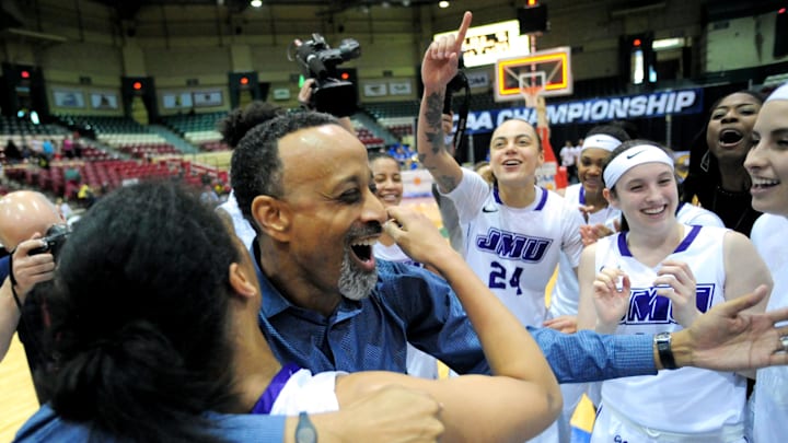 Mar 15, 2015; Upper Marlboro, MD, USA; James Madison Dukes head coach Kenny Brooks (center) celebrates after beating the Hofstra Pride 62-56 during the finals of the Colonial Conference Tournament at The Show Place Arena. Mandatory Credit: Evan Habeeb-Imagn Images