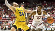 Dec 3, 2022; Tuscaloosa, Alabama, USA;  Alabama forward Brandon Miller (24) commits an offensive foul against South Dakota State guard Alex Arians (34) at Coleman Coliseum. Alabama won 78-65. Mandatory Credit: Gary Cosby Jr.-USA TODAY Sports