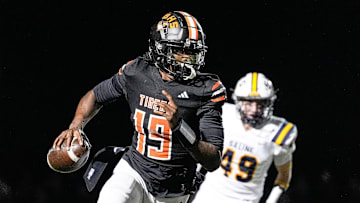 Belleville quarterback Bryce Underwood keeps the ball and runs against Saline during the second half of district final at Belleville High School in Belleville on Friday, Nov. 8, 2024.