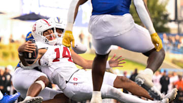 Nov 29, 2024; San Jose, California, USA; Stanford Cardinal quarterback Ashton Daniels (14) gets tackled by San Jose State Spartans linebacker Taniela Latu (4) in the third quarter at CEFCU Stadium. Mandatory Credit: Eakin Howard-Imagn Images
