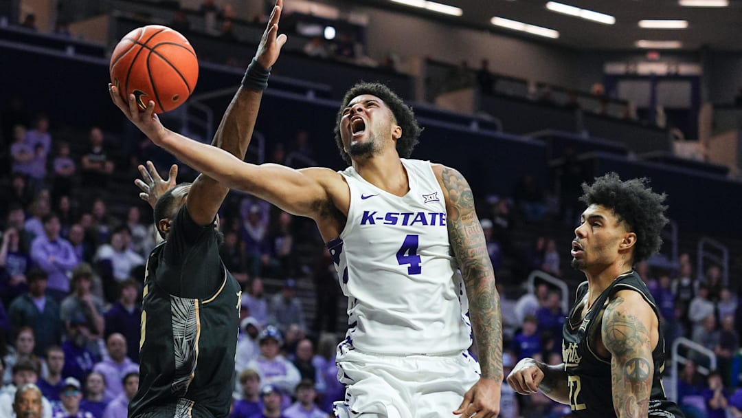 Kansas State guard PJ Haggerty (4) shoots against UCF forward Devan Cambridge (left) and guard Chris Johnson during the second half at Bramlage Coliseum. 