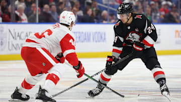 Mar 12, 2024; Buffalo, New York, USA;  Buffalo Sabres center Dylan Cozens (24) carries the puck up ice as Detroit Red Wings defenseman Jeff Petry (46) defends during the second period at KeyBank Center. Mandatory Credit: Timothy T. Ludwig-Imagn Images