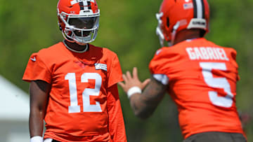 Cleveland Browns quarterback Shedeur Sanders (12) watches quarterback Dillon Gabriel (5) during day two of NFL rookie minicamp at the Cleveland Browns training facility on Saturday, May 10, 2025, in Berea, Ohio.
