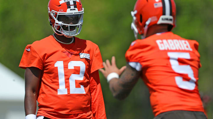 Cleveland Browns quarterback Shedeur Sanders (12) watches quarterback Dillon Gabriel (5) during day two of NFL rookie minicamp at the Cleveland Browns training facility on Saturday, May 10, 2025, in Berea, Ohio.