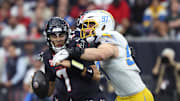 Jan 11, 2025; Houston, Texas, USA; Los Angeles Chargers outside linebacker Joey Bosa (97) sacks Houston Texans quarterback C.J. Stroud (7) during the first quarter in an AFC wild card game at NRG Stadium