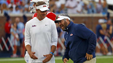 Sep 21, 2024; Oxford, Mississippi, USA; Mississippi Rebels head coach Lane Kiffin (left) shares a laugh with defensive coordinator Pete Golding (right) during warm ups prior to the game against the Georgia Southern Eagles at Vaught-Hemingway Stadium. Mandatory Credit: Petre Thomas-Imagn Images
