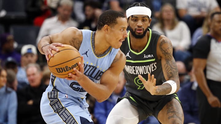 Nov 26, 2023; Memphis, Tennessee, USA; Memphis Grizzlies guard Desmond Bane (22) handles the ball as Minnesota Timberwolves guard Nickeil Alexander-Walker (9) defends during the first half at FedExForum. Mandatory Credit: Petre Thomas-Imagn Images
