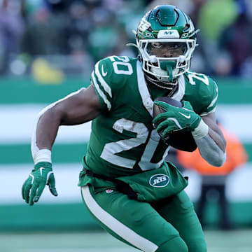 Dec 22, 2024; East Rutherford, New Jersey, USA; New York Jets running back Breece Hall (20) runs with the ball against the Los Angeles Rams during the second quarter at MetLife Stadium. 