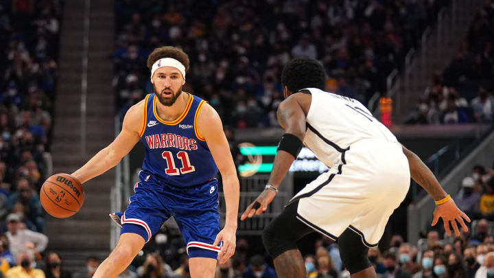 Jan 29, 2022; San Francisco, California, USA; Golden State Warriors guard Klay Thompson (11) dribbles the ball against Brooklyn Nets guard Kyrie Irving (11) in the second quarter at the Chase Center. Mandatory Credit: Cary Edmondson-USA TODAY Sports