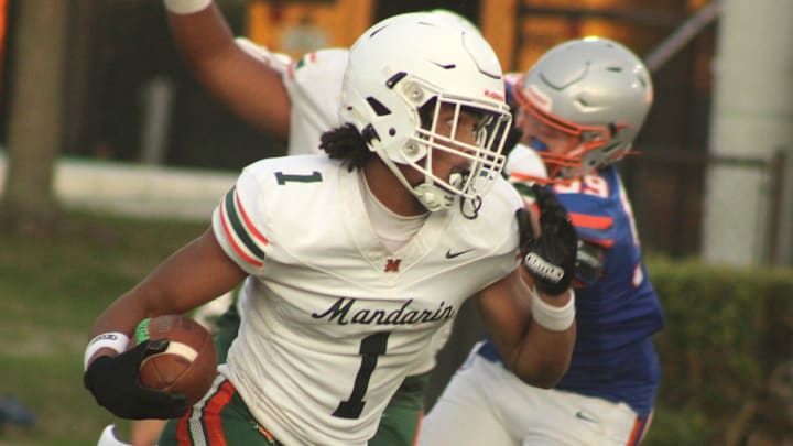 Mandarin wide receiver Brysen Wright (1) makes an open-field cut on his way to a 77-yard touchdown reception during a high school spring football game against Bolles on May 22, 2025. Mandarin wide receiver Brysen Wright (1) makes an open-field cut on his way to a 77-yard touchdown reception during a high school spring football game against Bolles on May 22, 2025.
