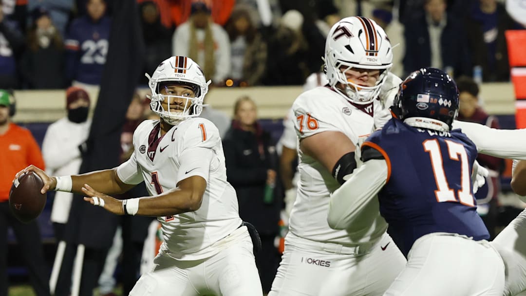 Nov 29, 2025; Charlottesville, Va.; Virginia Tech quarterback Kyron Drones (1) passes the ball under pressure from Virginia defensive end Mitchell Melton (17).