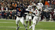 Nov 29, 2025; Charlottesville, Virginia, USA; Virginia Tech Hokies cornerback Thomas Williams (23) attempts to intercept a pass intended for Virginia Cavaliers wide receiver Trell Harris (11) in the third quarter at Scott Stadium. Mandatory Credit: Geoff Burke-Imagn Images