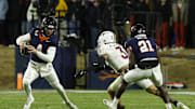 Nov 29, 2025; Charlottesville, Virginia, USA; Virginia Cavaliers quarterback Chandler Morris (4) scrambles from Virginia Tech Hokies linebacker Kaleb Spencer (3) in the second quarter at Scott Stadium. Mandatory Credit: Geoff Burke-Imagn Images