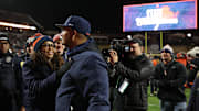 Nov 29, 2025; Charlottesville, Virginia, USA; Virginia Cavaliers head coach Tony Elliott (R) celebrates with Virginia director of athletics Carla Williams (L) on the field after the Cavaliers' game against the Virginia Tech Hokies at Scott Stadium. Mandatory Credit: Geoff Burke-Imagn Images