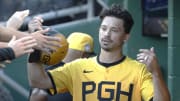 Jul 19, 2024; Pittsburgh, Pennsylvania, USA;  Pittsburgh Pirates left fielder Bryan Reynolds (10) celebrates in the dugout after scoring a run against the Philadelphia Phillies during the first inning at PNC Park. Mandatory Credit: Charles LeClaire-USA TODAY Sports