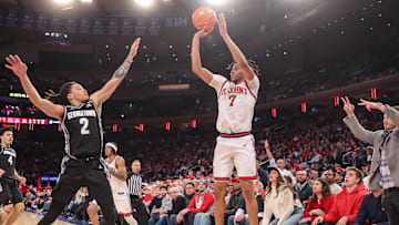 Jan 14, 2025; New York, New York, USA;  St. John's basketball guard Simeon Wilcher (7) takes a three point shot past Georgetown Hoyas guard Malik Mack (2) in the second half at Madison Square Garden.
