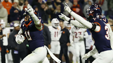 Nov 29, 2025; Charlottesville, Virginia, USA; Virginia Cavaliers linebacker Maddox Marcellus (11) celebrates after intercepting a pass against the Virginia Tech Hokies in the first quarter at Scott Stadium. Mandatory Credit: Geoff Burke-Imagn Images
