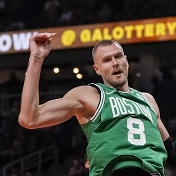 Mar 28, 2024; Atlanta, Georgia, USA; Boston Celtics center Kristaps Porzingis (8) dunks against the Atlanta Hawks during the first half at State Farm Arena. Mandatory Credit: Dale Zanine-Imagn Images